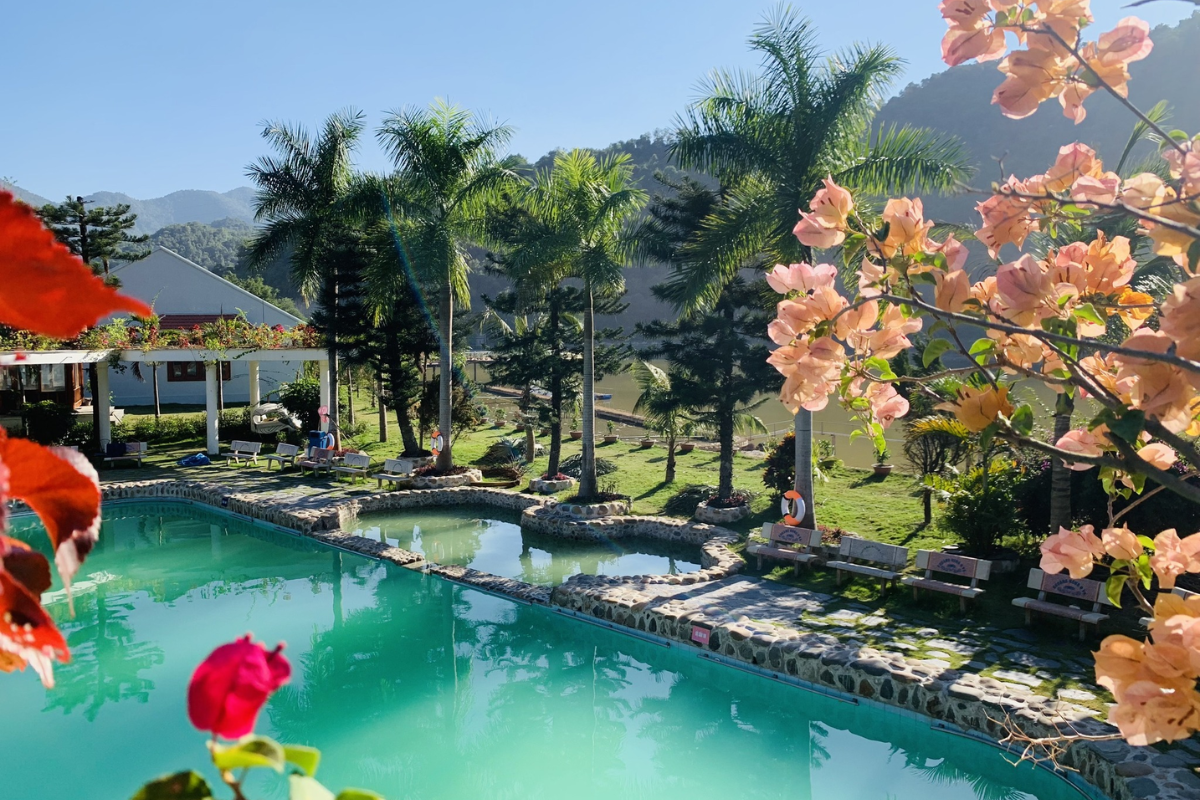 Visitors relaxing at U Va hot spring surrounded by green hills in Dien Bien